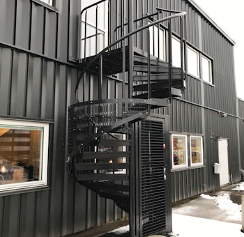 Powder coated outdoor spiral staircase with quarter protective cage