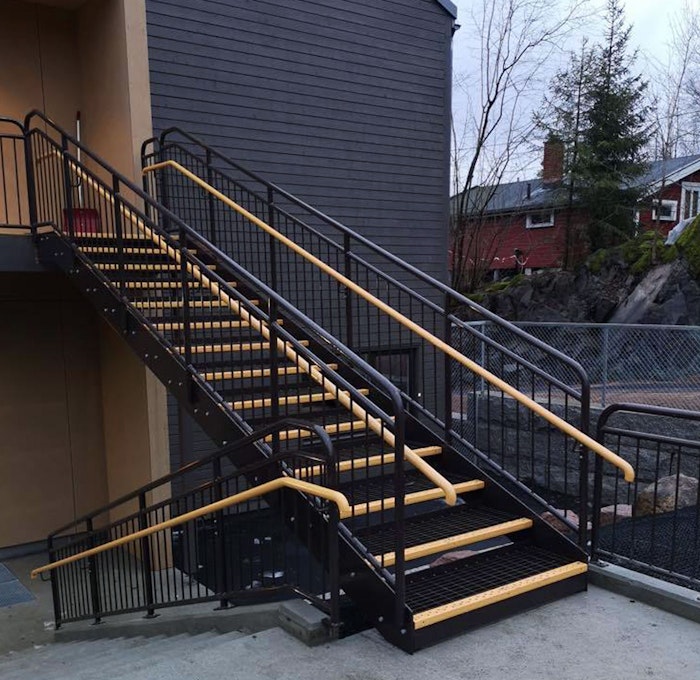Powder coated straight staircase with grating steps and inner handrail in wood