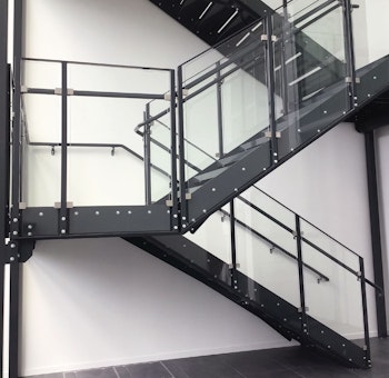 Straight staircase with powder coated inner handrail and glass railing