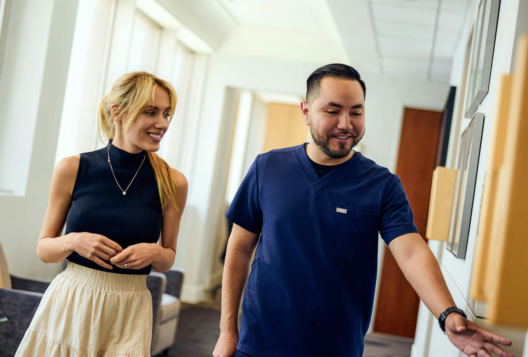 patient walking in hallway with staff member