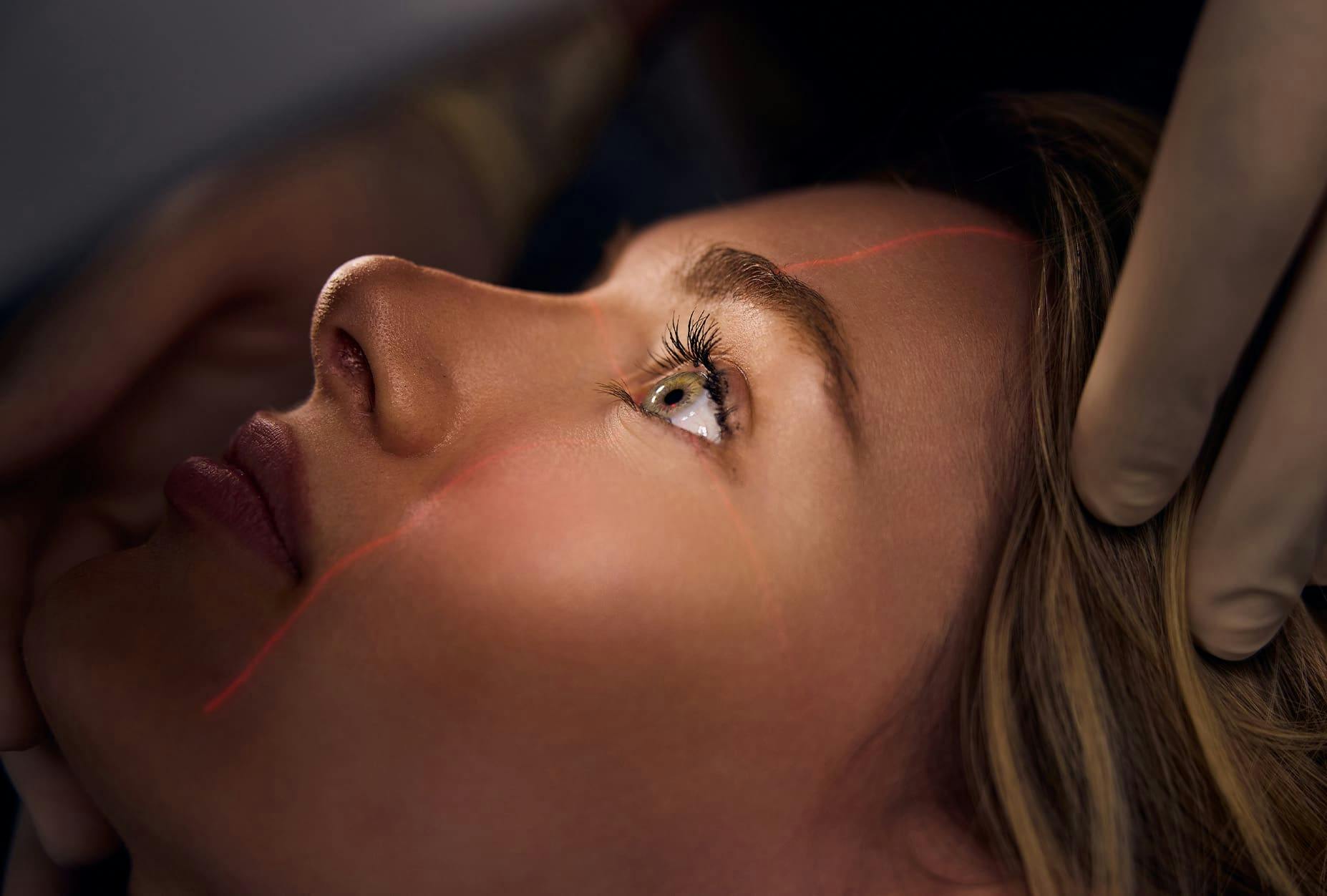 patient aligning her eyes to the laser for staff to view her eyes