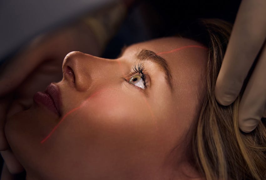 patient aligning her eyes to the laser for staff to view her eyes