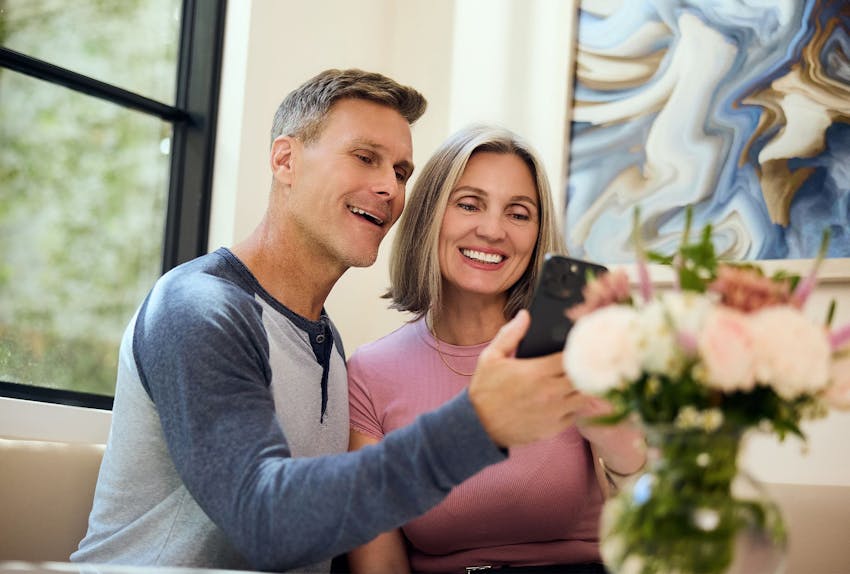 couple looking at a phone on the couch