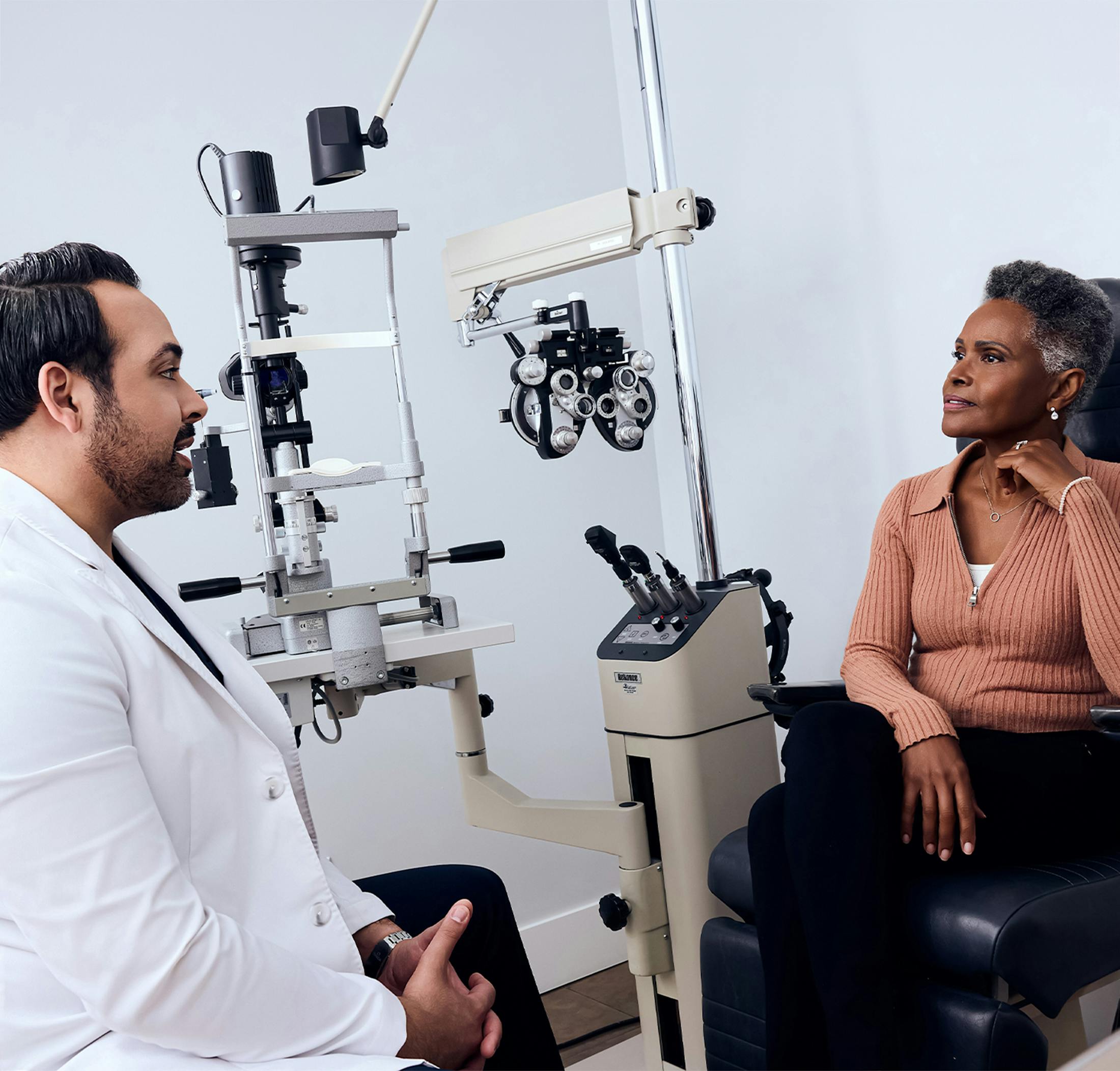 patient in machine to have his eyes viewed by staff