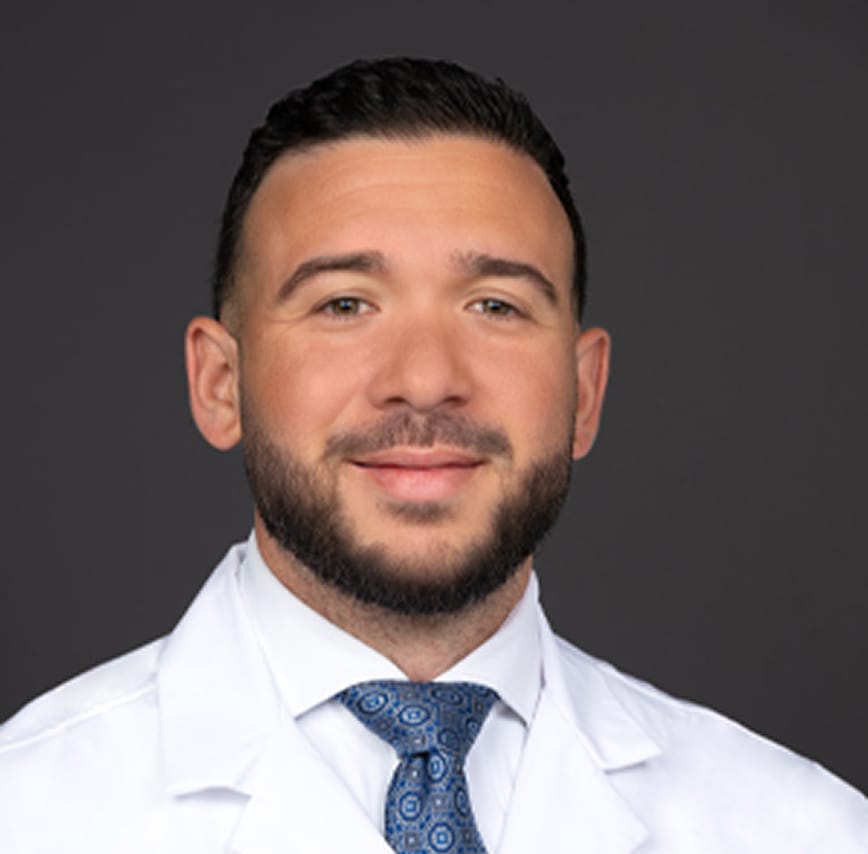 Dr Hassan Nasser in white collared shirt and lab jacket