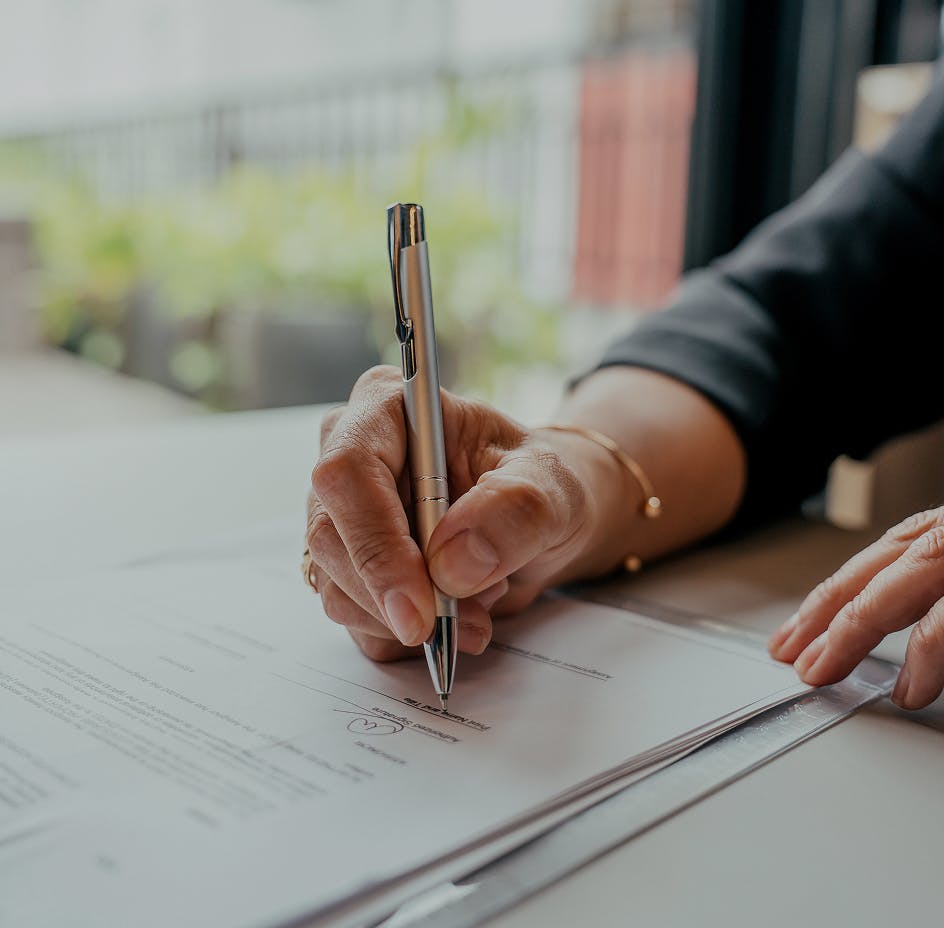 client hand signing paperwork