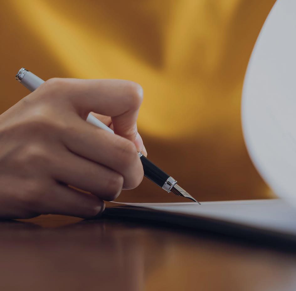 client hand with pen signing paper