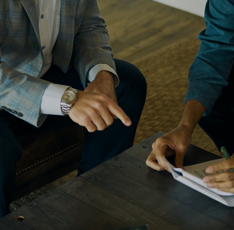 attorney pointing at papers in a clients hand