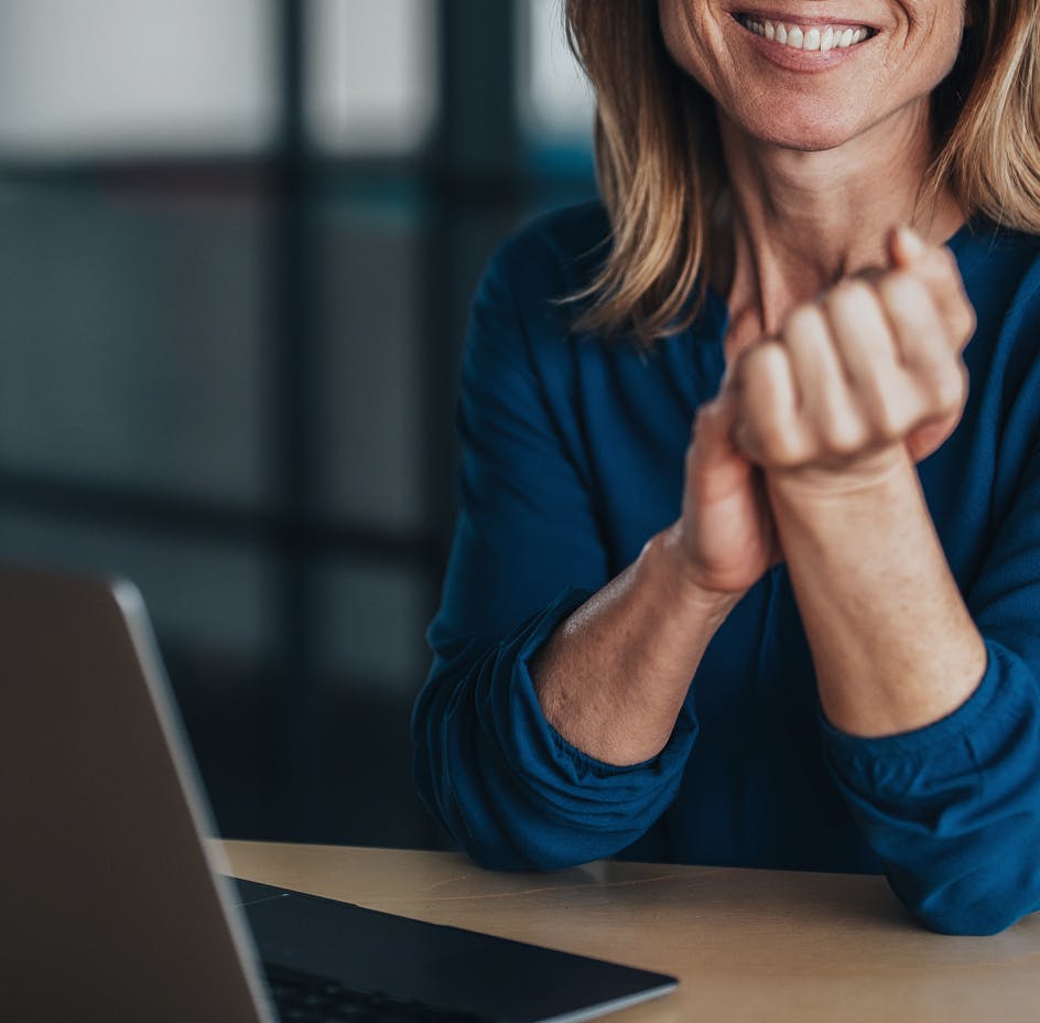 women smiling in front of computer screen