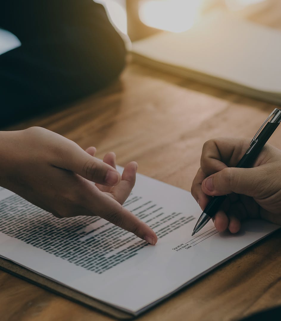 person pointing at document