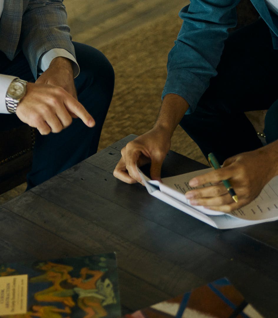 person pointing at documents