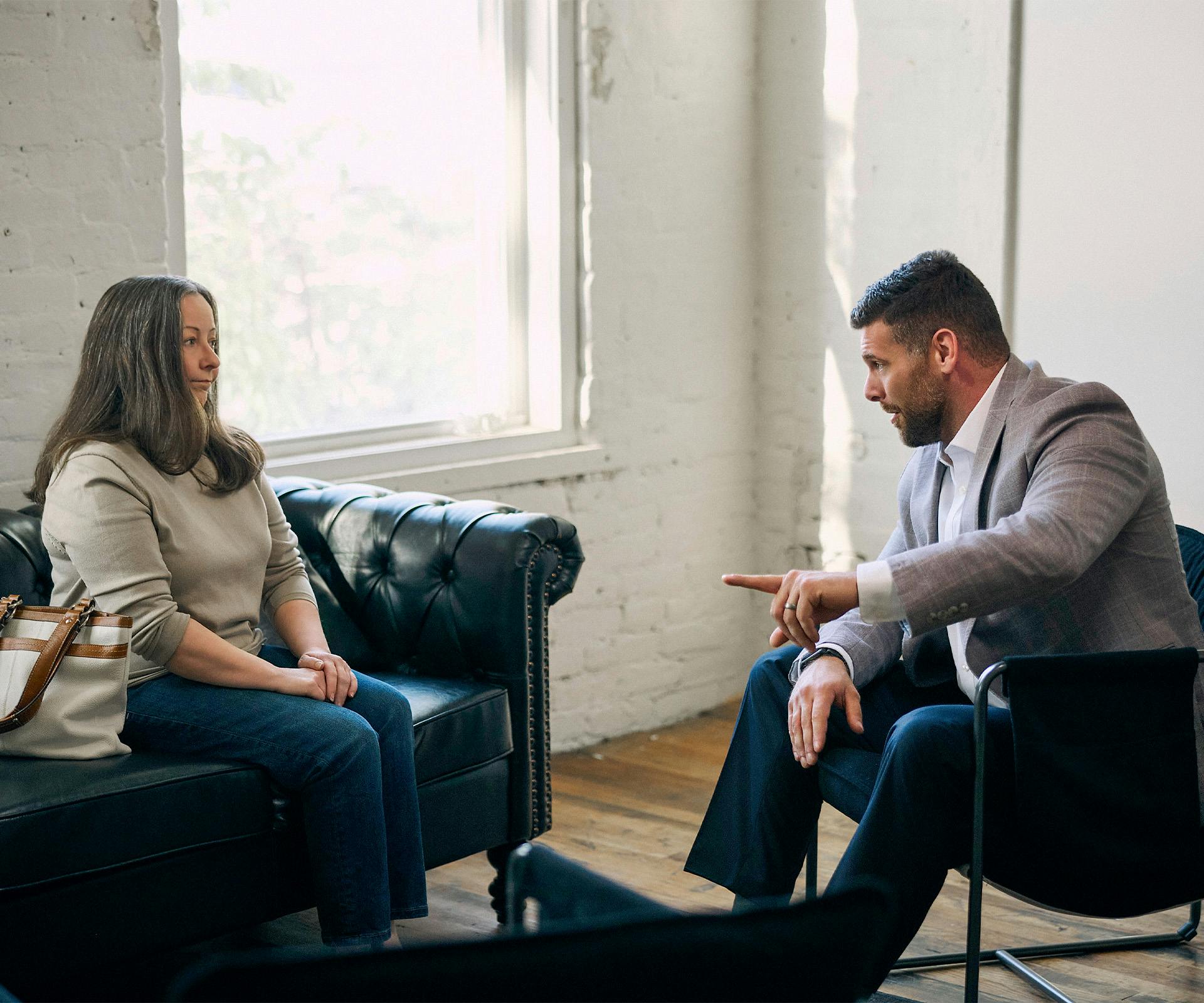 two people speaking on the couch