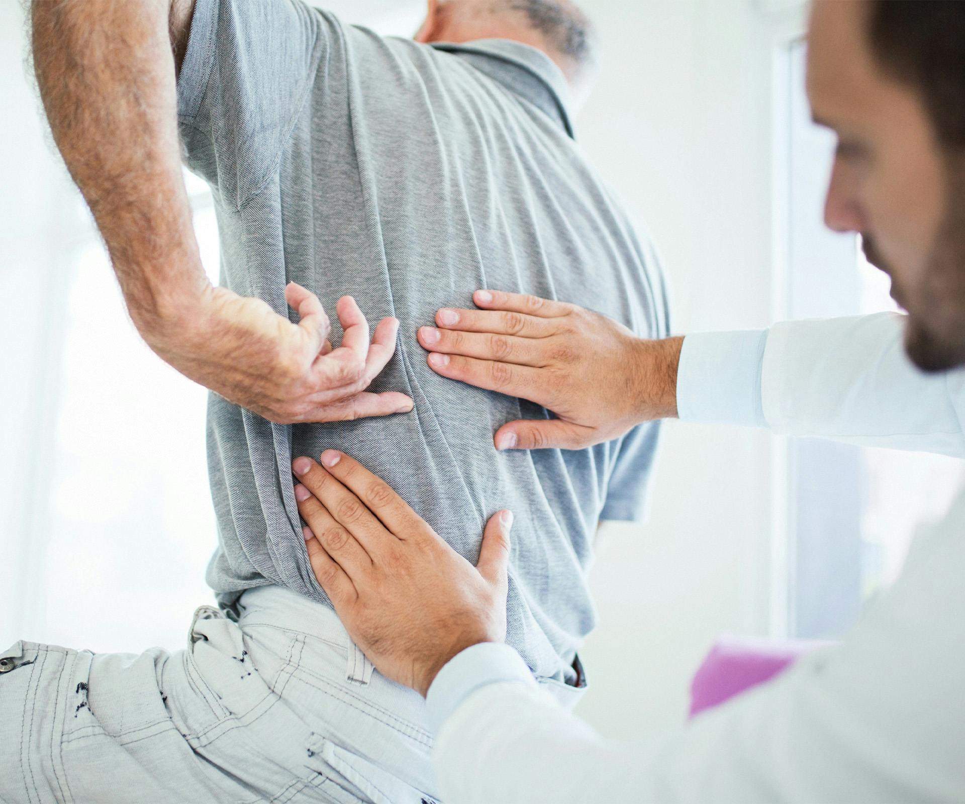 doctor touching patient's back