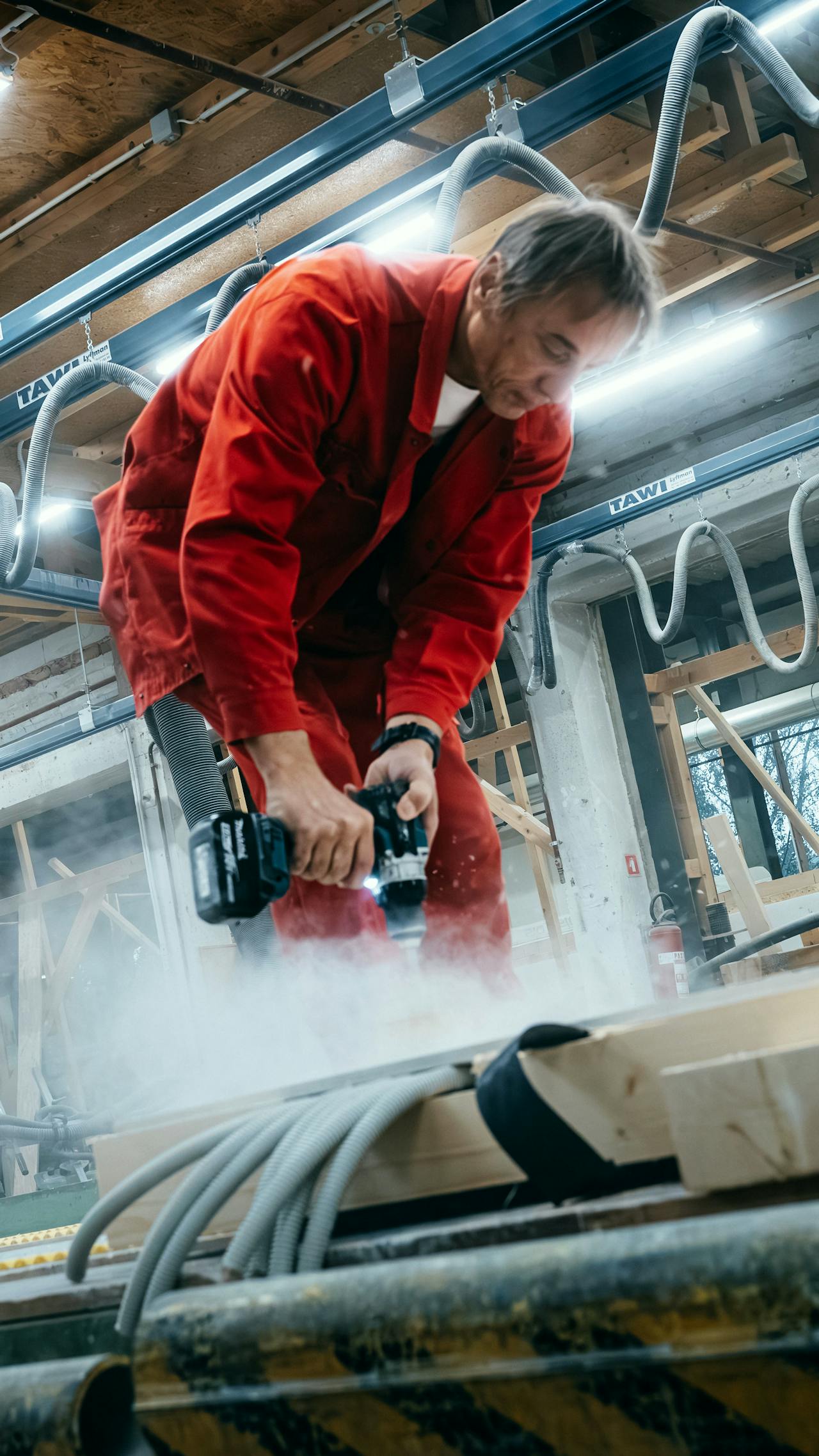 Two craftspeople precisely making a timber structural element