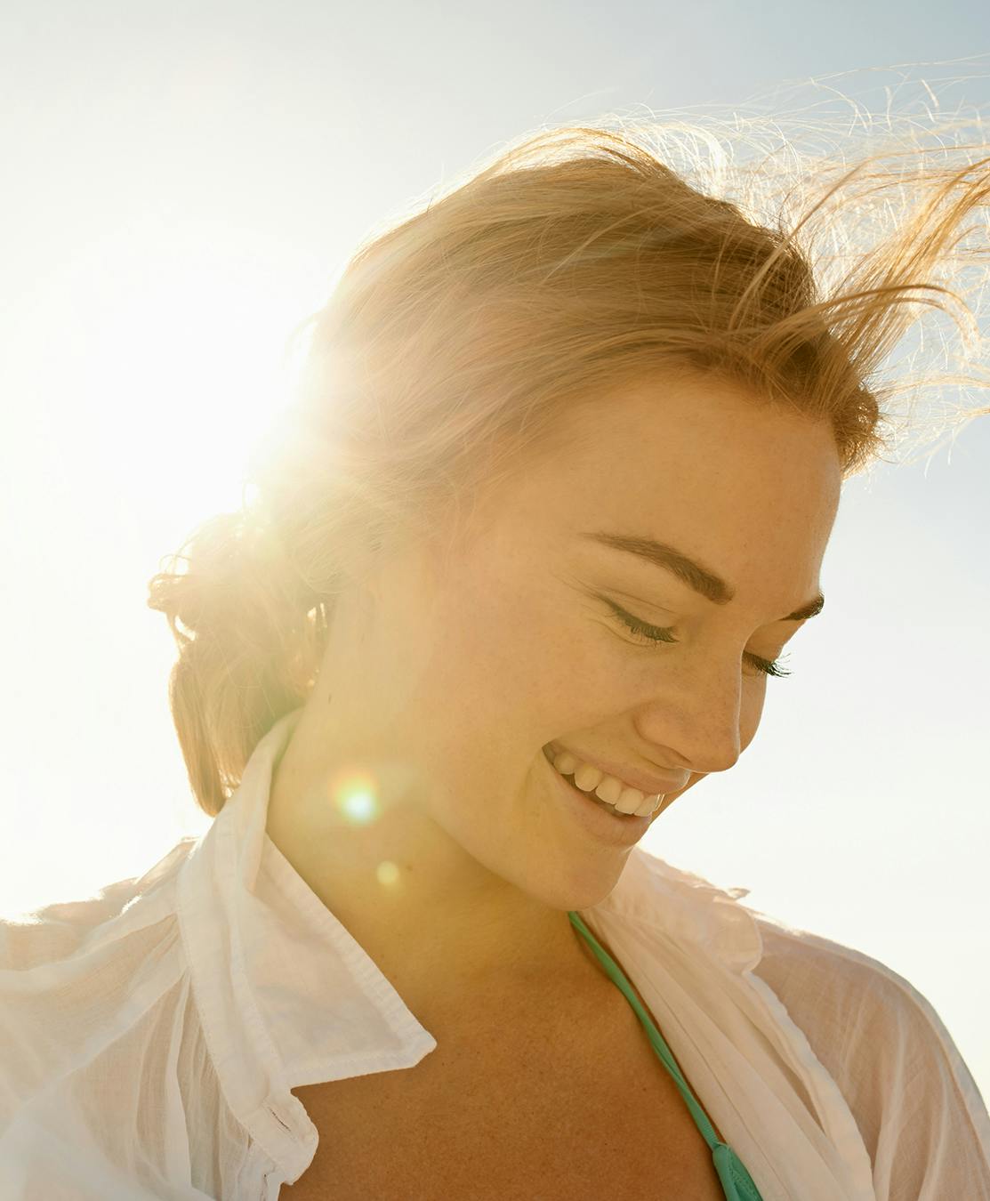 Woman smiling down at ground
