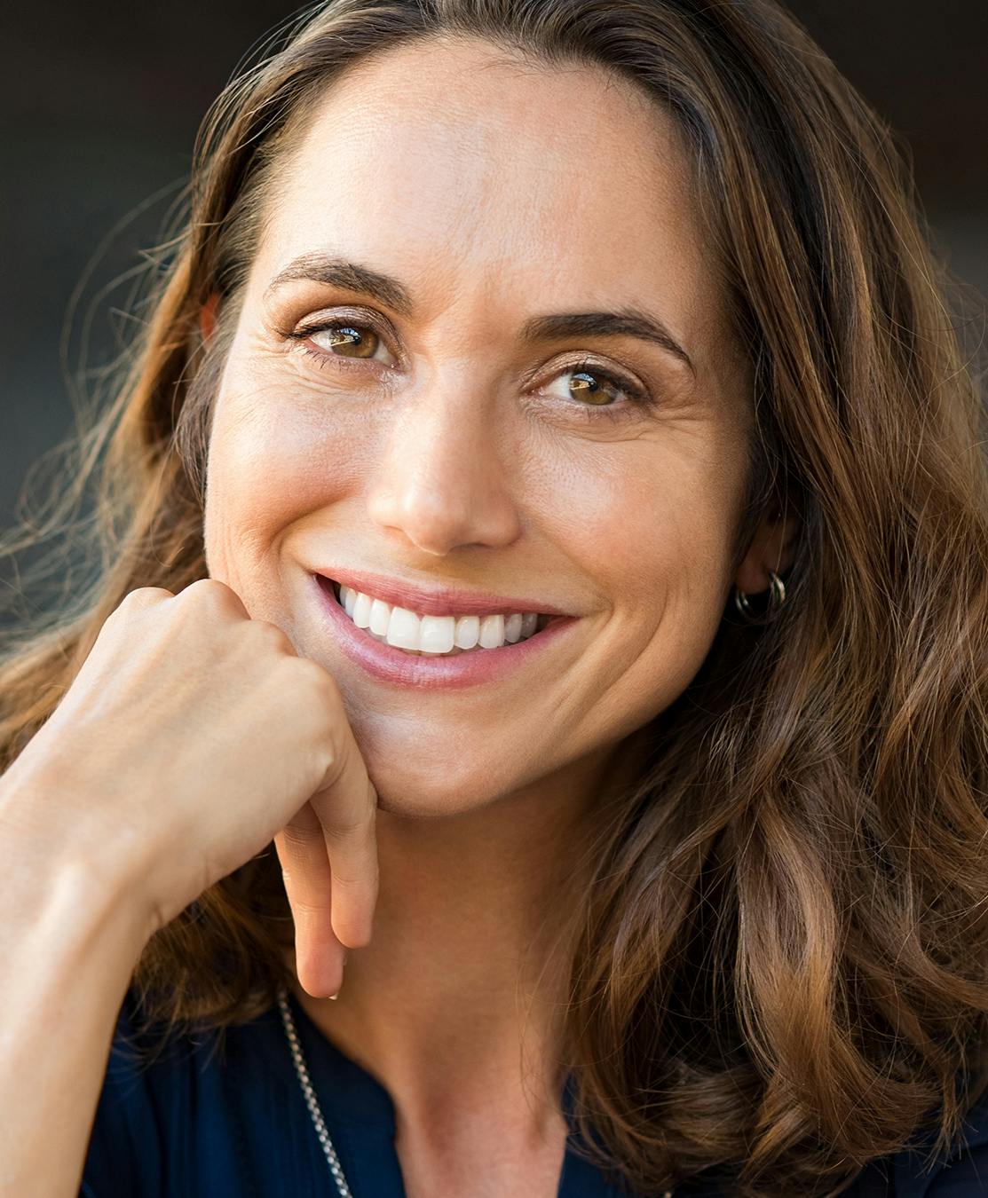 Woman smiling happily into camera