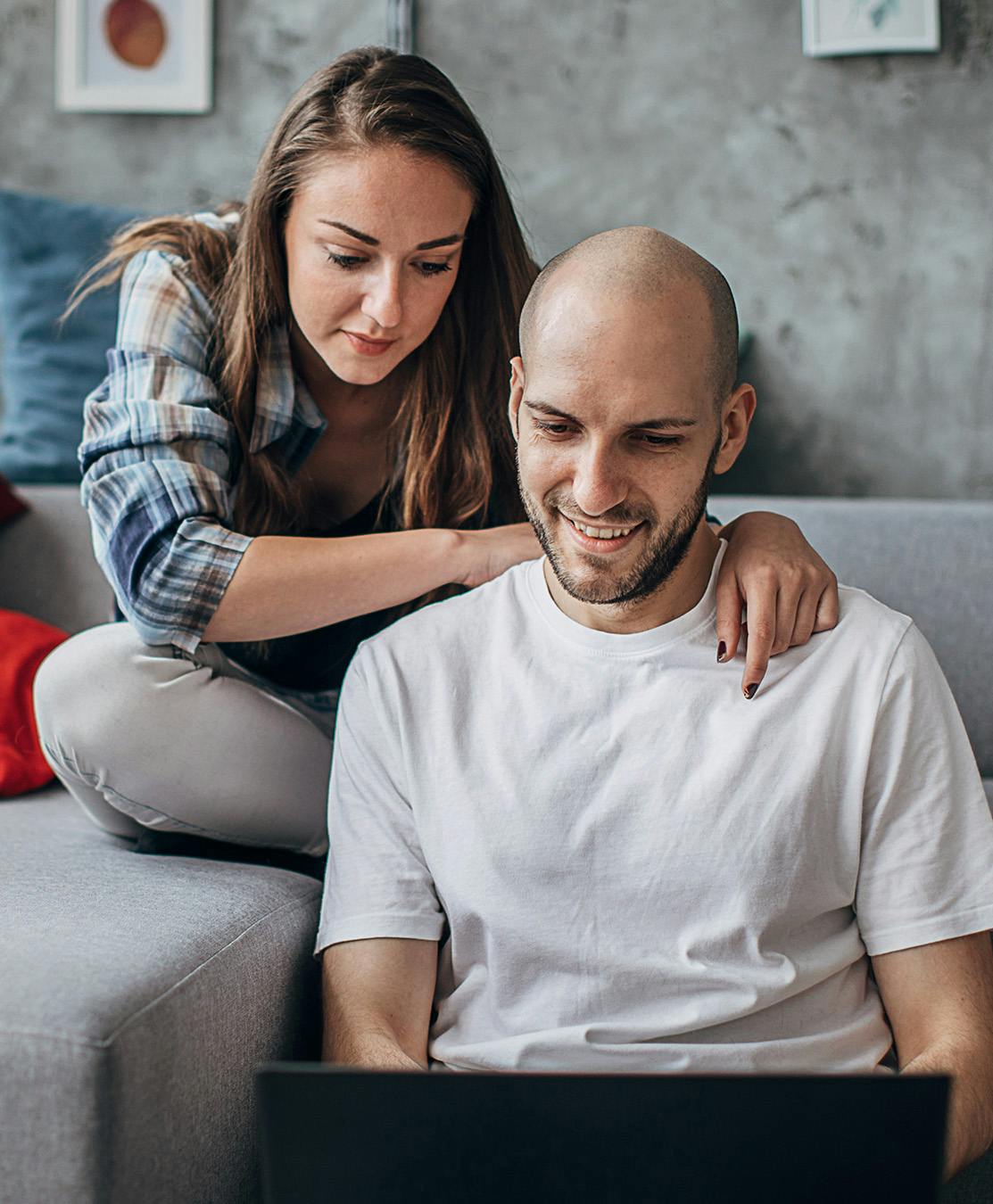 Man and woman looking at a computer