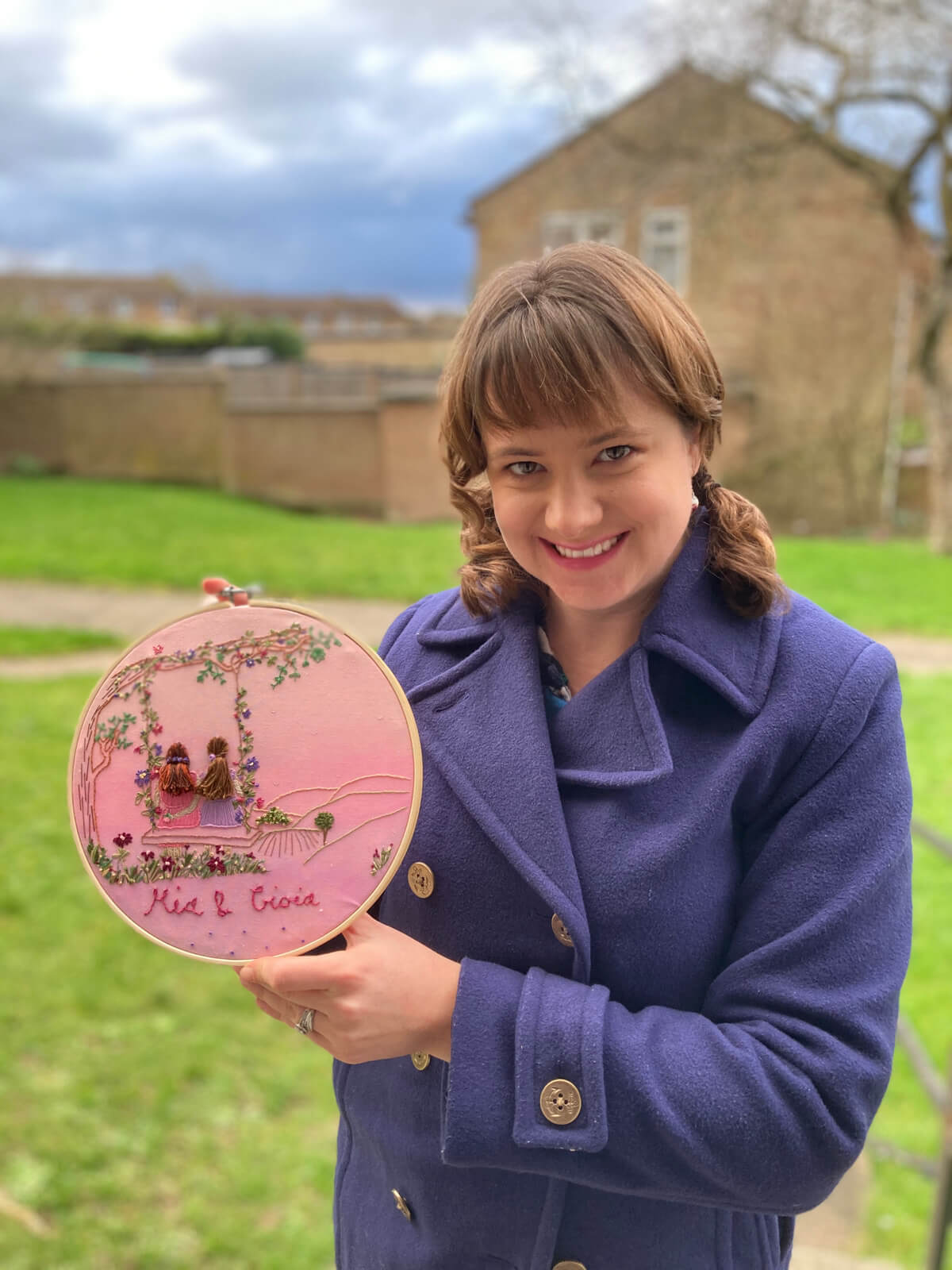 Me holding one of my embroidered hoop designs