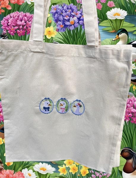 Three ducks in embroidered hoops