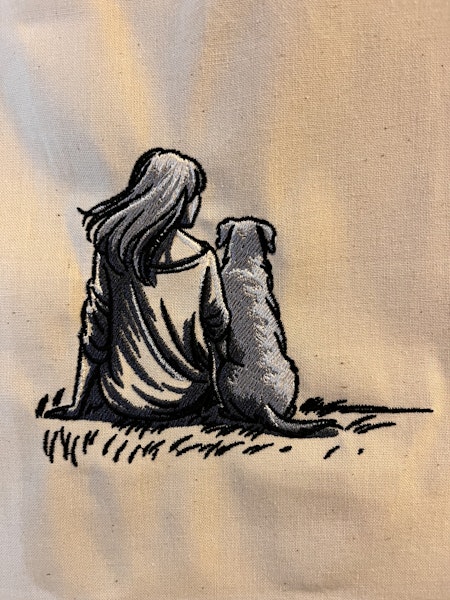 Woman with dog sitting on grass