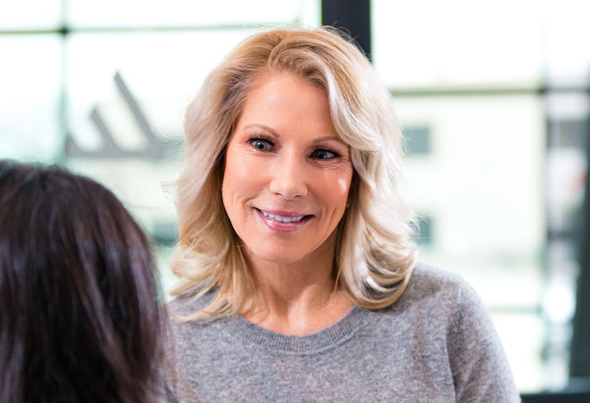 Blonde woman wearing a grey top