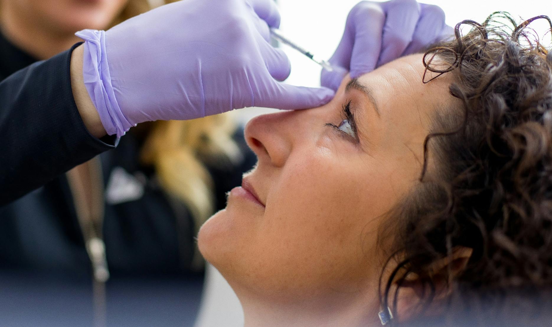 Woman being injected by provider