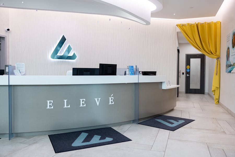 Modern reception area of Eleve with curved front desk
