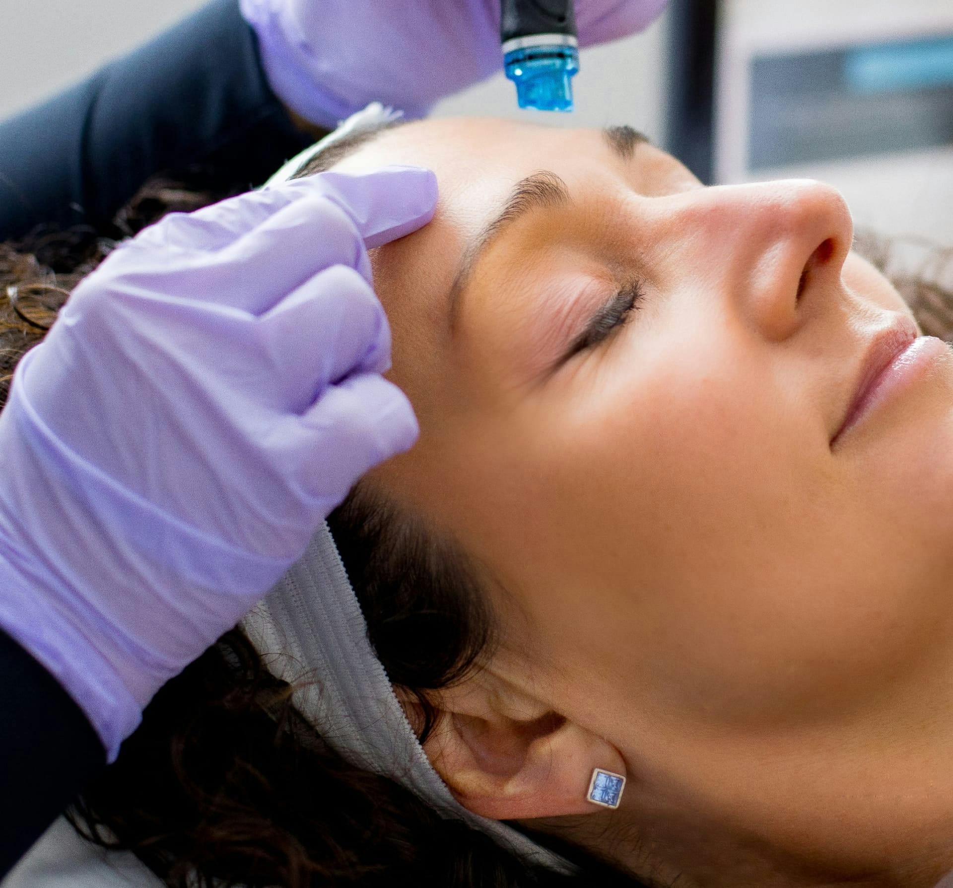 Woman getting a treatment to her face