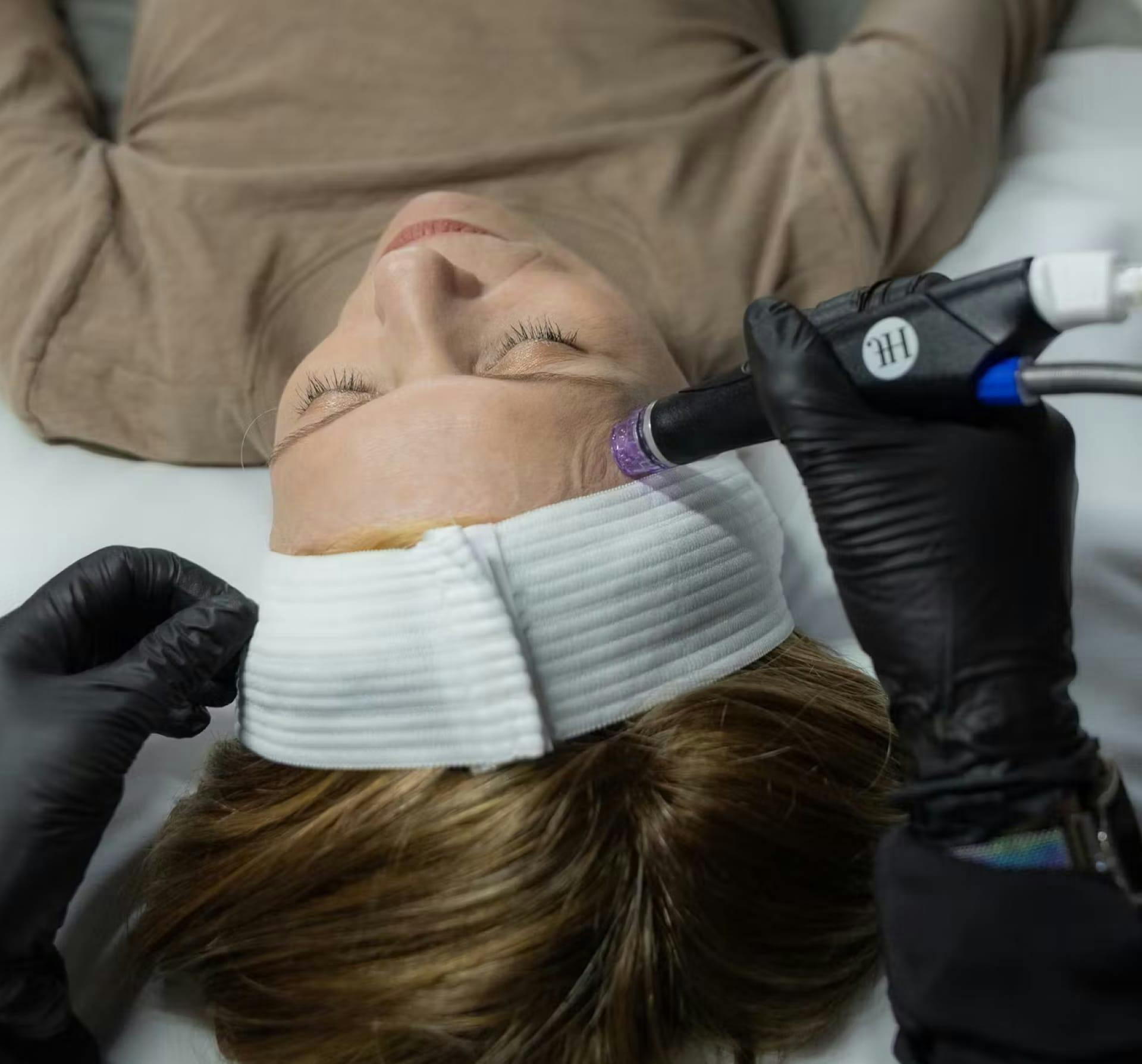 Woman getting hydrafacial on her face
