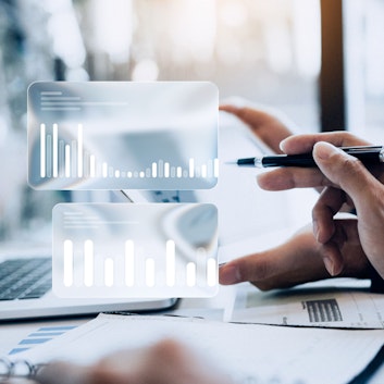 People looking at tablet. Charts.