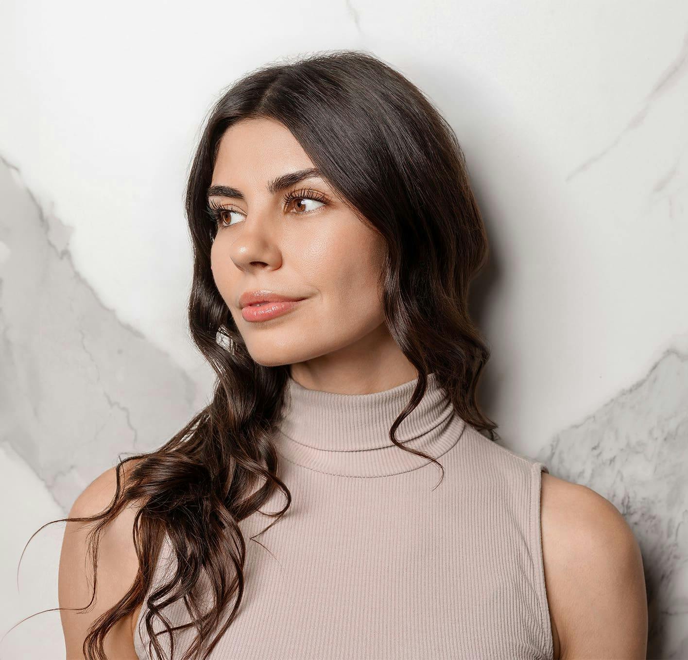 woman leaning against marbled wall