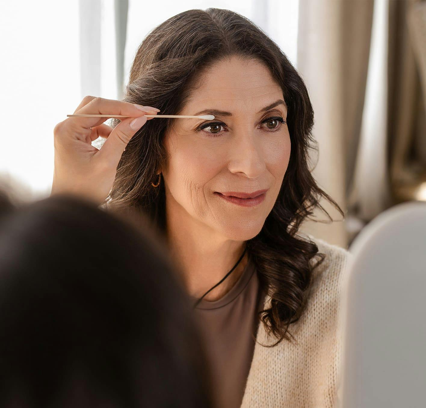 woman getting her eyelids examined