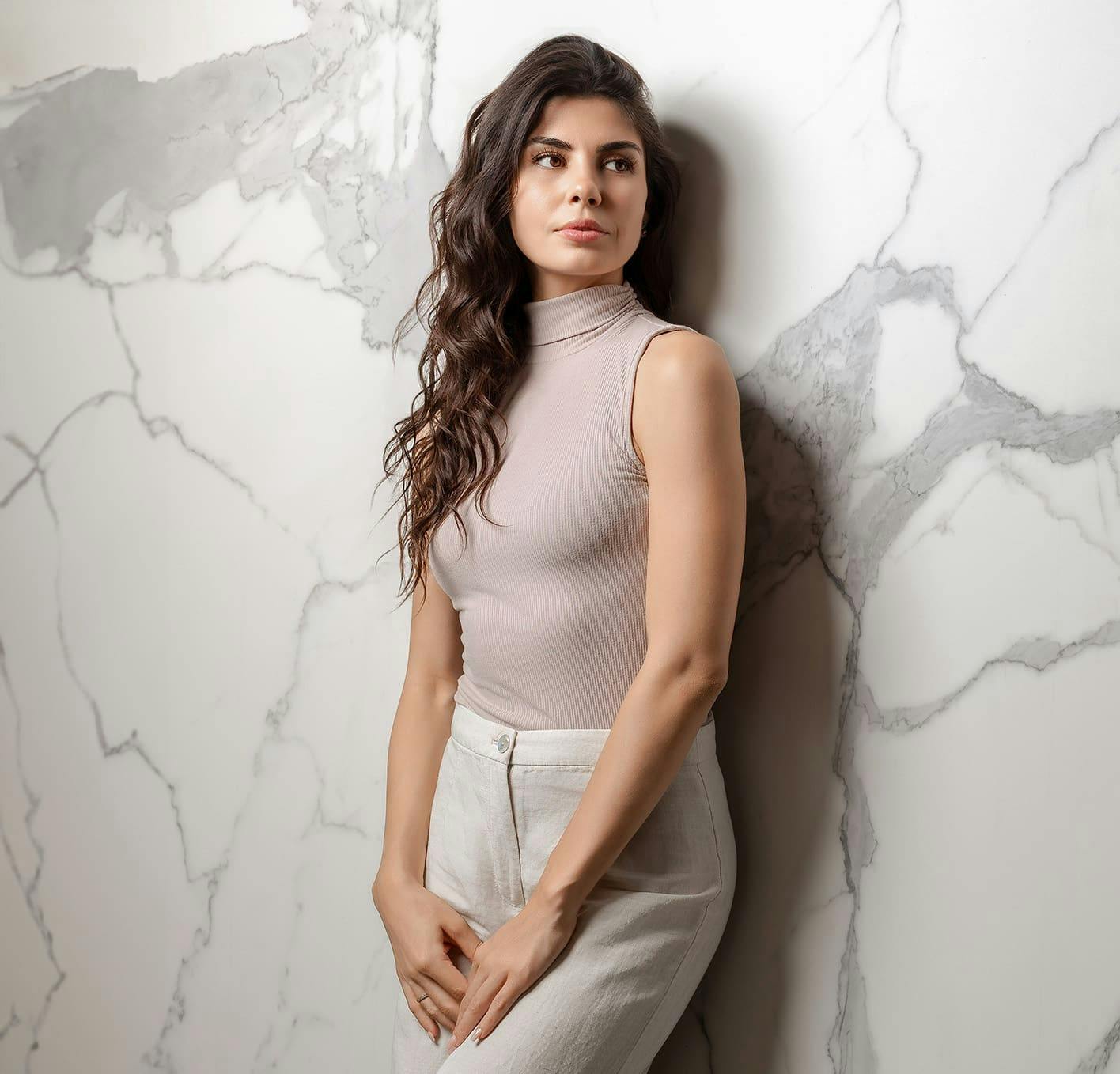 woman leaning against marble wall
