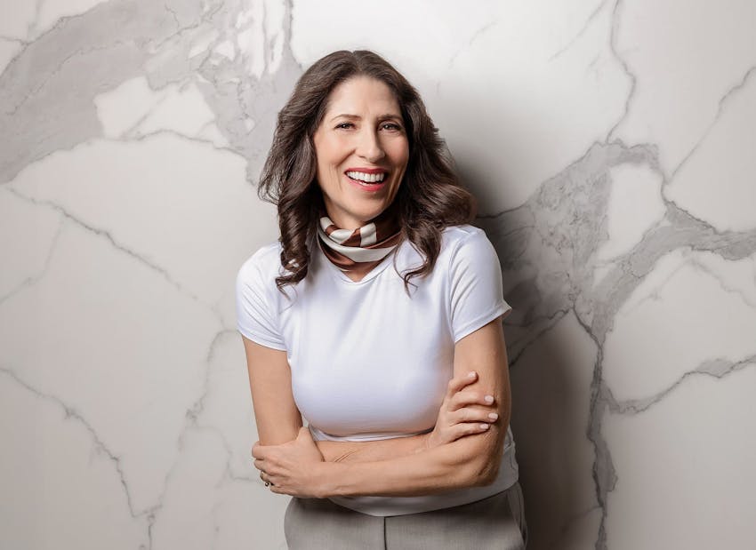 woman smiling with her arms crossed