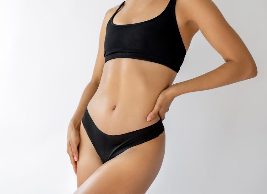 woman's body with her hand on her hip