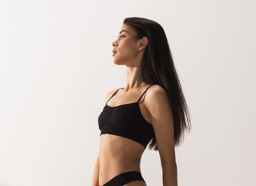 woman facing the left in black underwear set