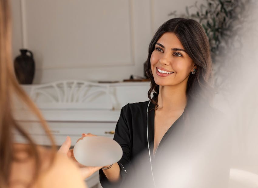 woman looking at breast implant