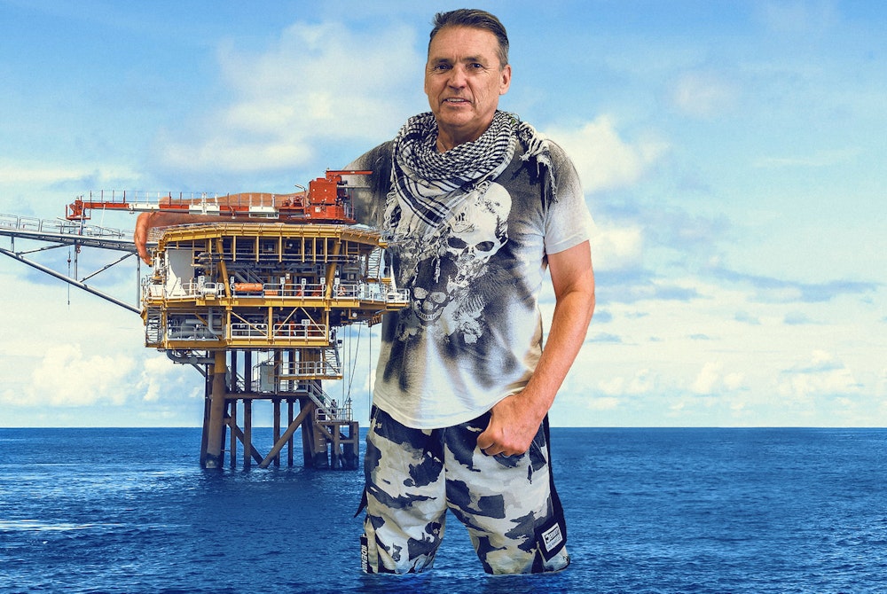 Dale Vince hugging a north sea oil platform