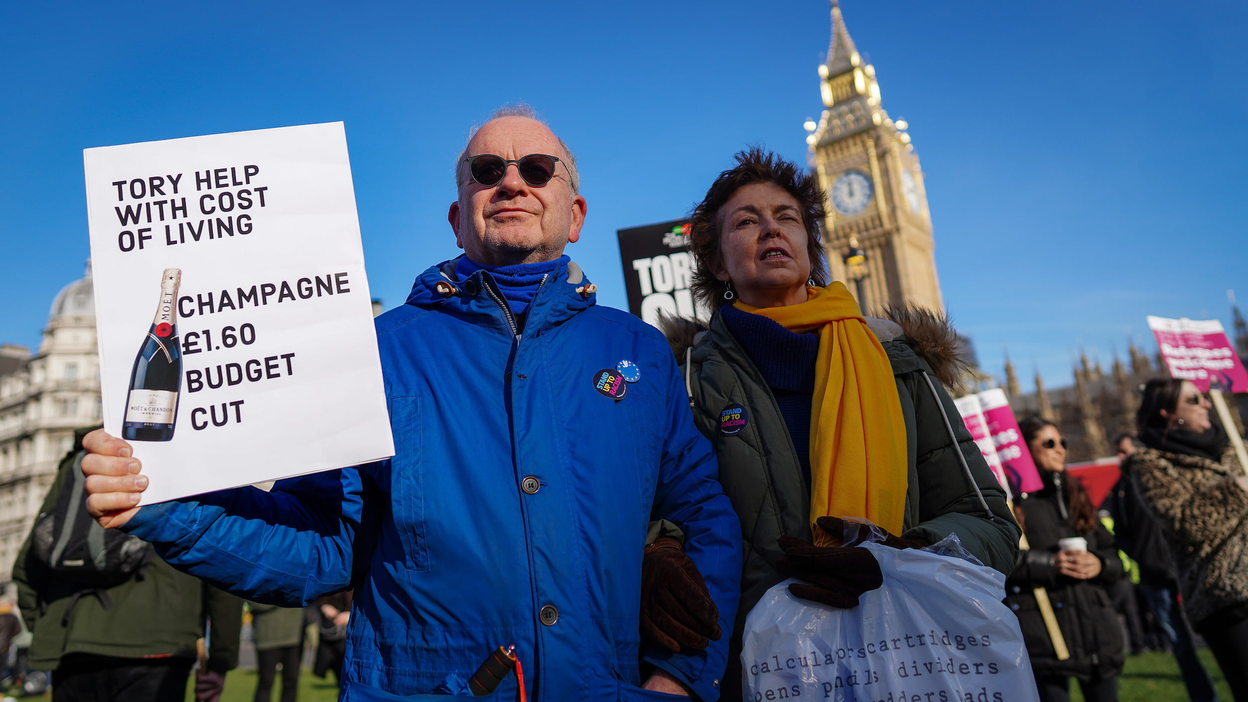 Protester_with_placard_'Tory_help_with_cost_of_living_-_Champagne_£1.60_budget_cut.'