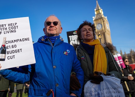 Protester_with_placard_'Tory_help_with_cost_of_living_-_Champagne_£1.60_budget_cut.'