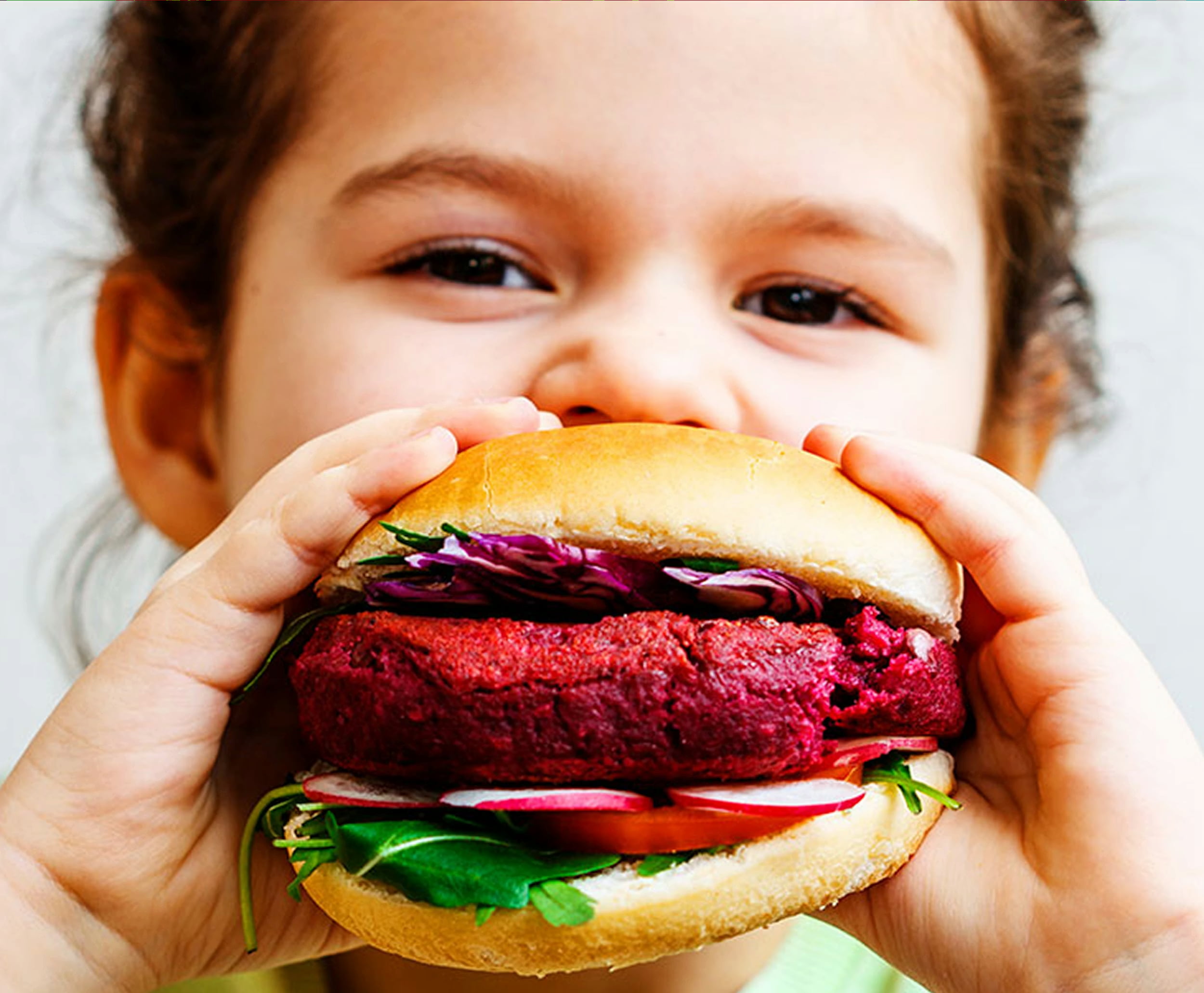 Child with a vegan burger