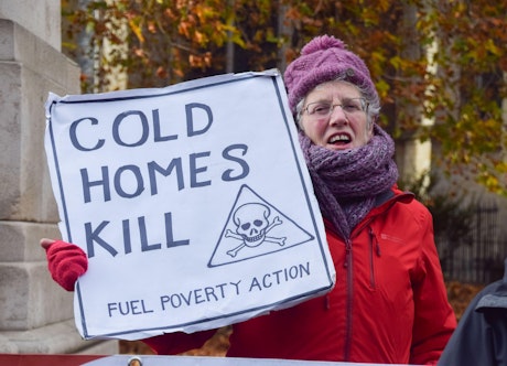 Protester with sign reading "cold homes kill"