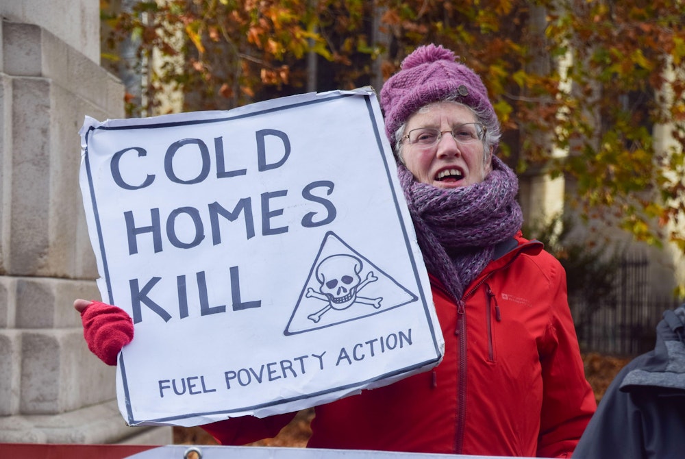 Protester with sign reading "cold homes kill"