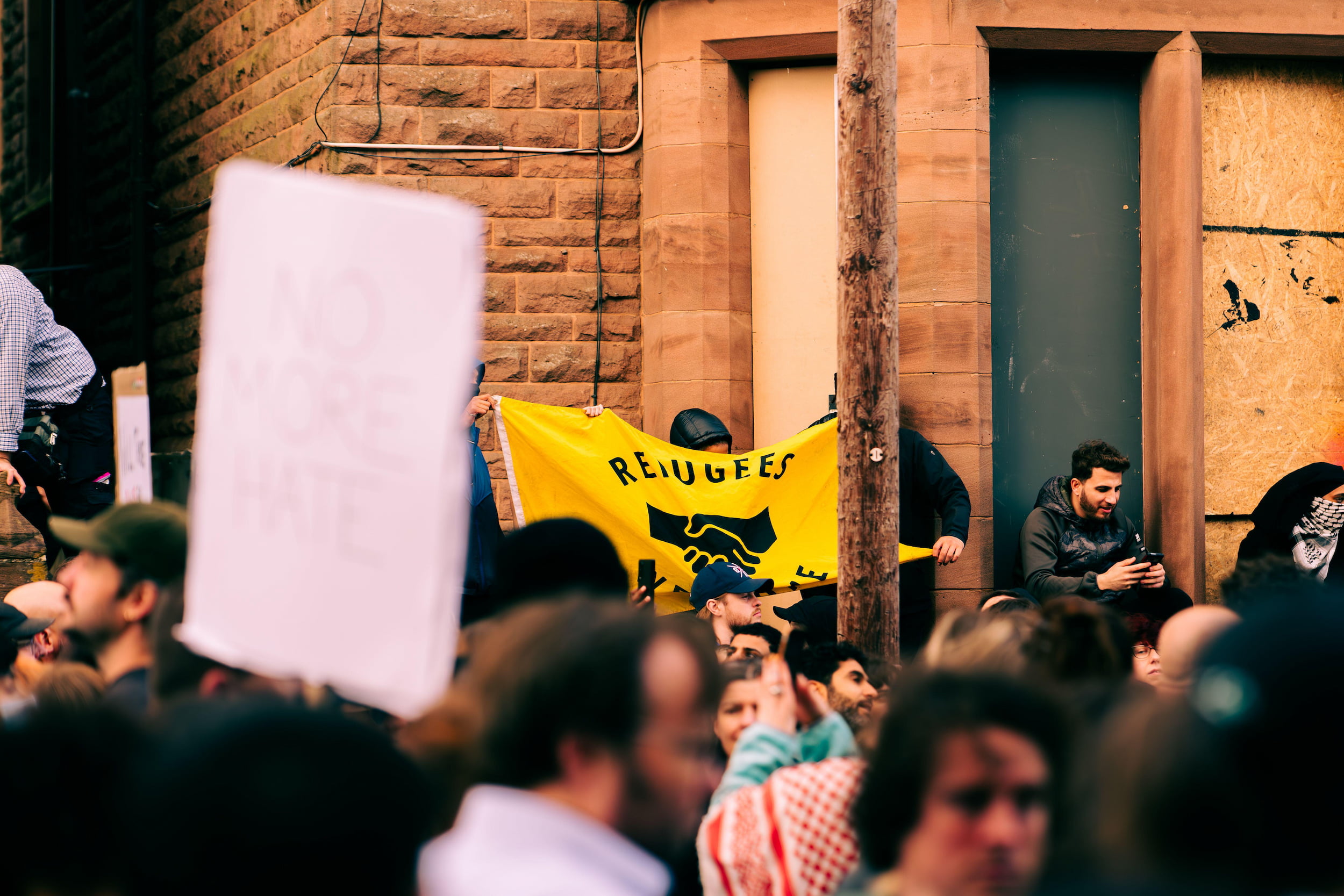 Protestor in Liverpool with sign reading "refugees welcome"