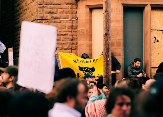 Protestor in Liverpool with sign reading "refugees welcome"
