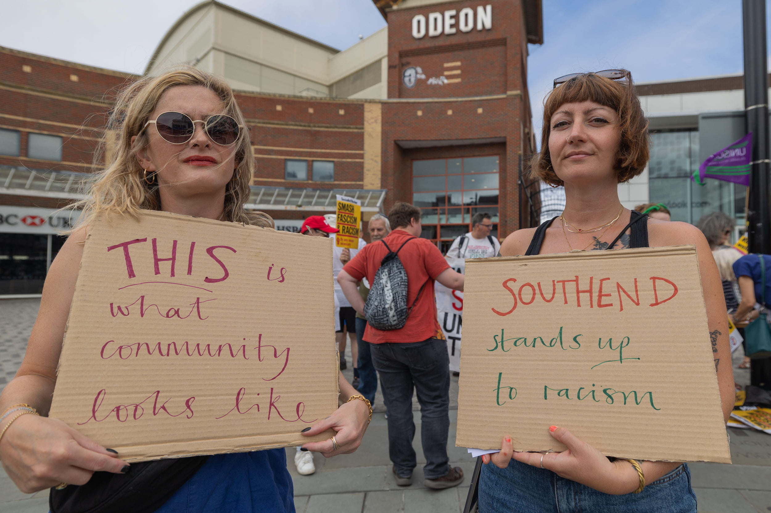 Protestor with 'this is what community looks like' sign