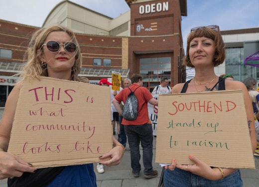 Protestor with 'this is what community looks like' sign