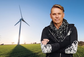 Dale Vince in front of a windmill