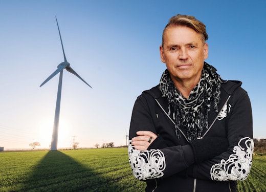 Dale Vince in front of a windmill