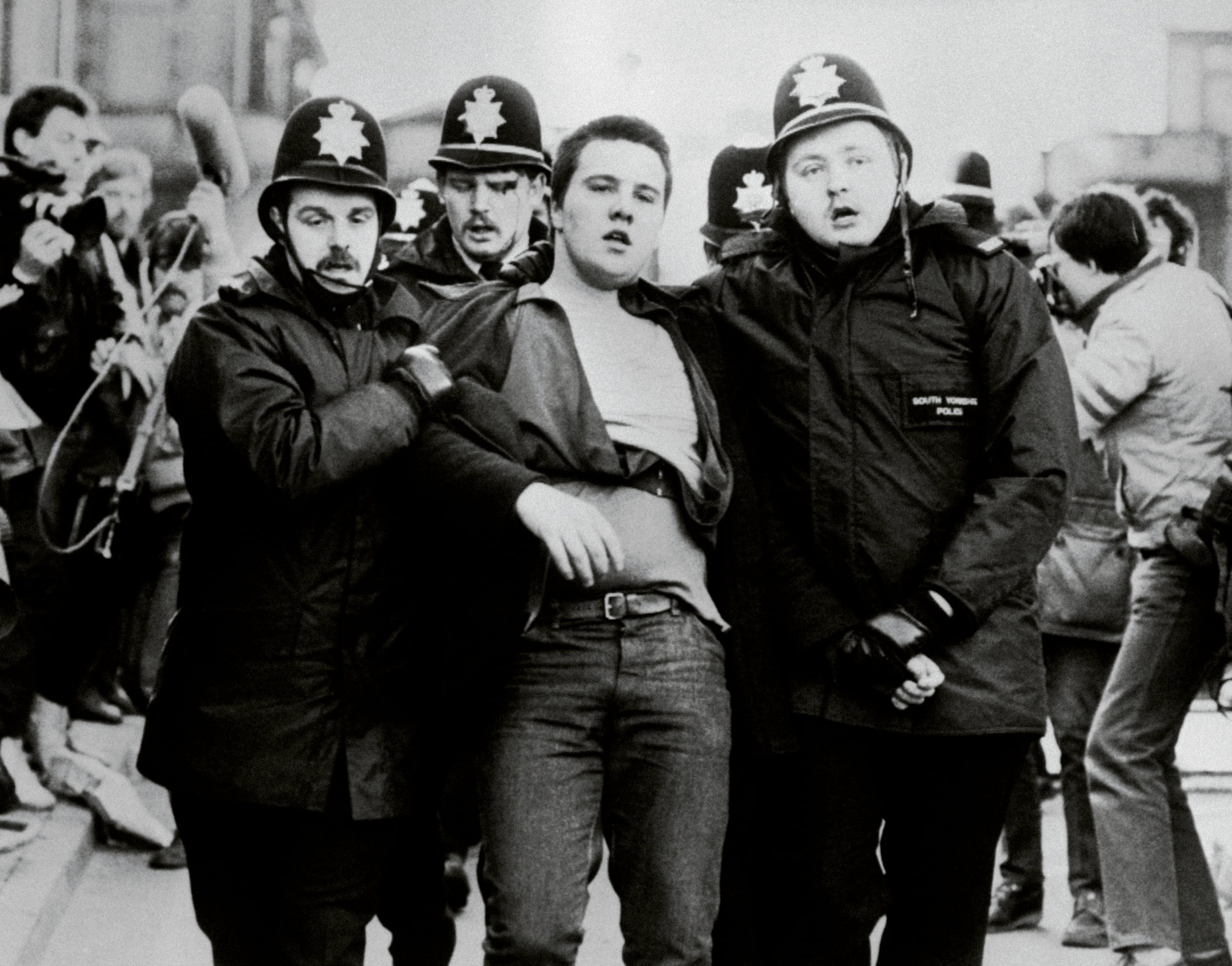 A protester is led away by police officers during clashes with miners in Sheffield in 1984